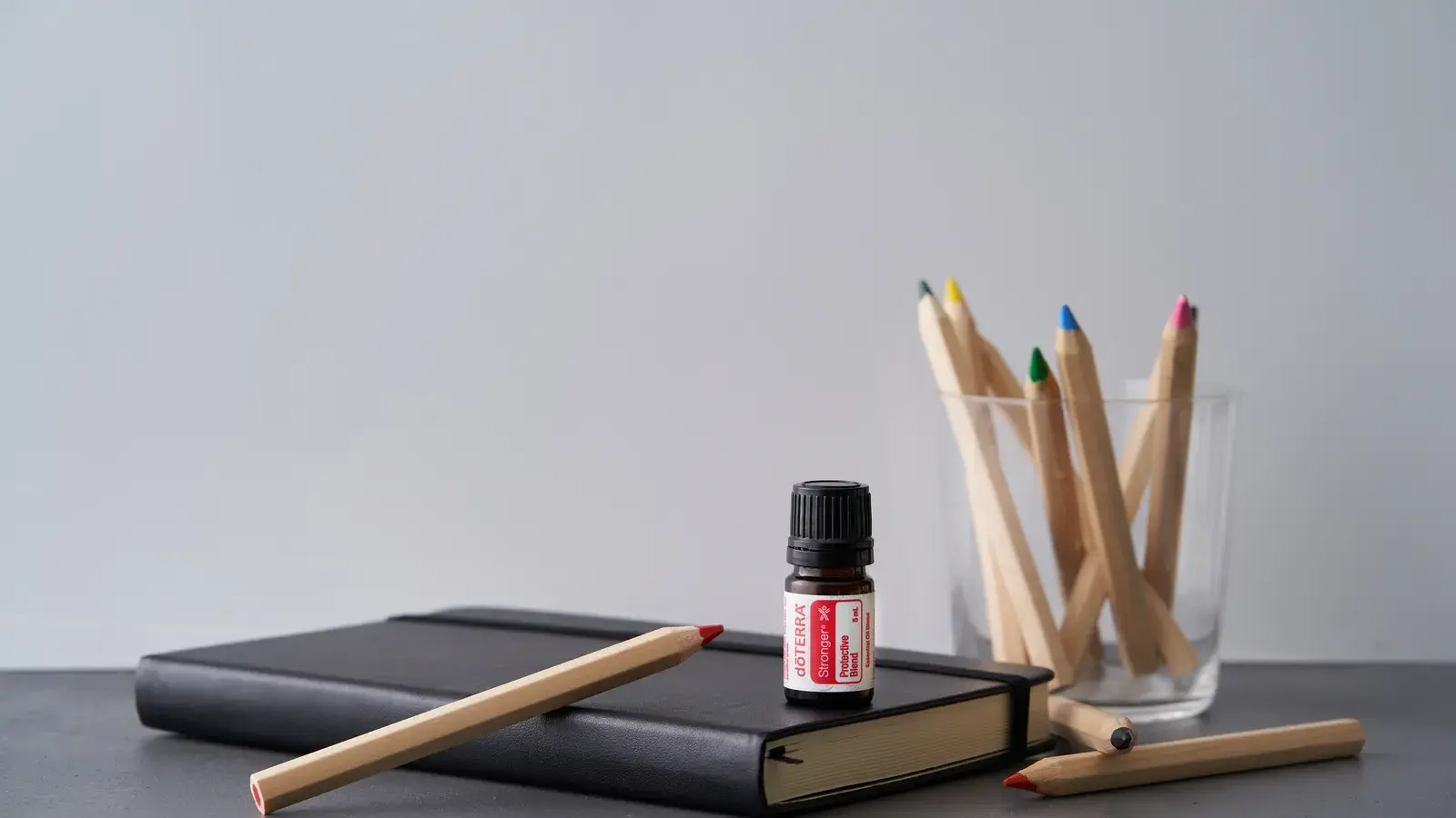 A creative setup with coloring pencils essential oil and a e5313c