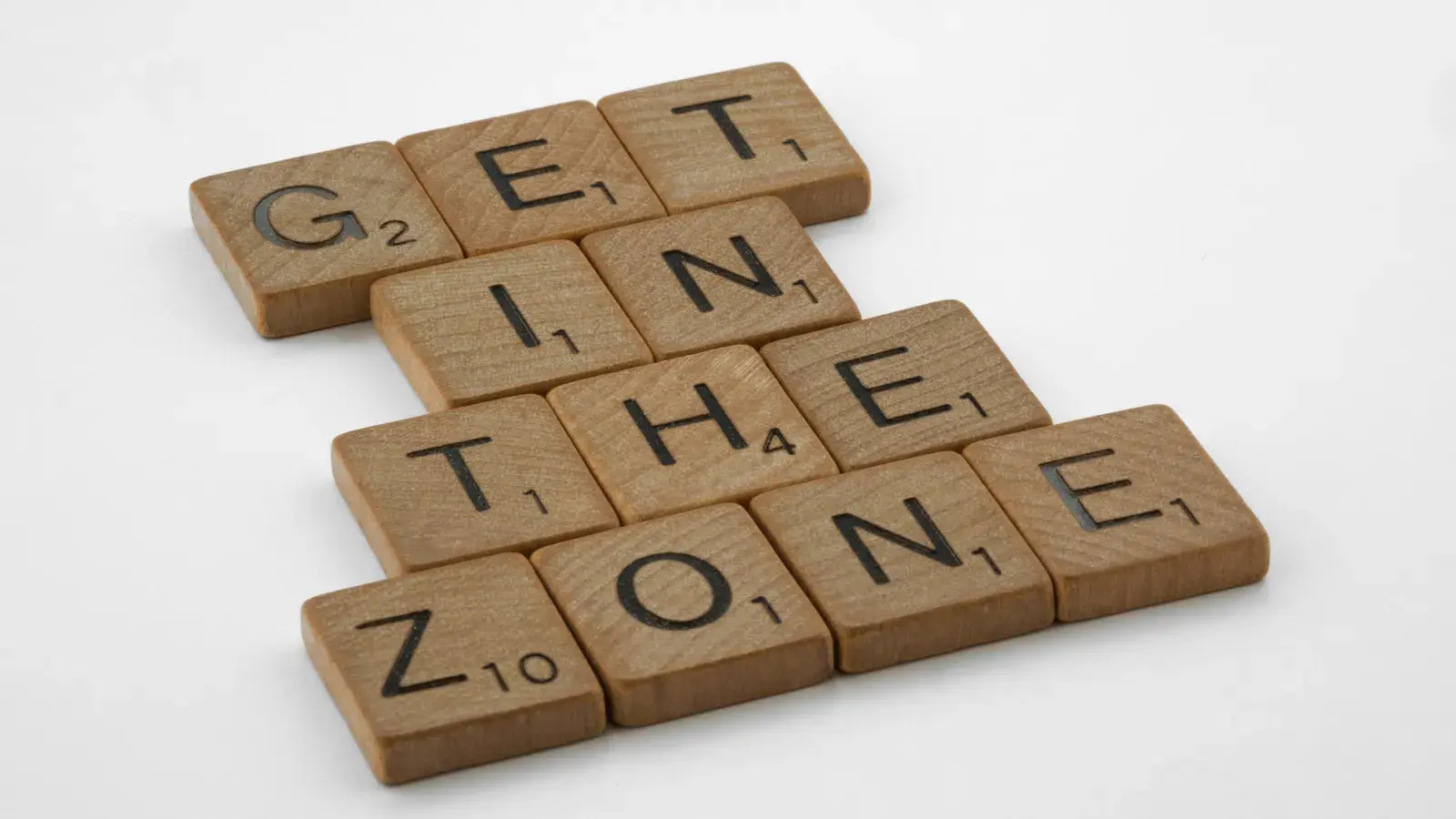 Wooden Scrabble tiles arranged to spell "Get in the Zone"
